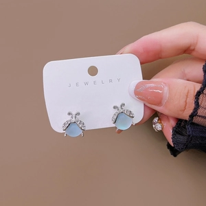 Silver ladybug earrings with light blue cat eye stones and white crystal accents
