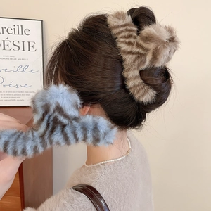 Detail of plush tiger print claw clip showing soft faux fur texture and sturdy large design
