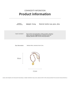 Detail of double-layer leather necklace with heart lock pendant and golden glass beads