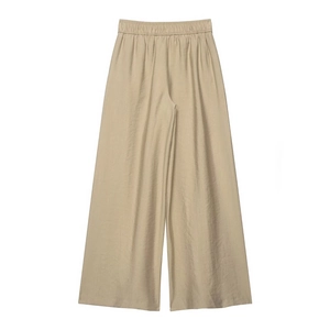Detail of khaki wide-leg trousers showing elastic high waist and satin fabric texture
