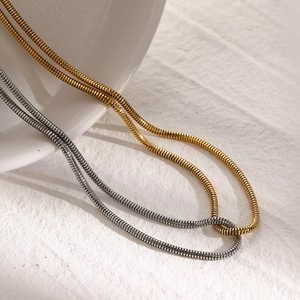 Detailed view of two-tone gold and silver stainless steel flat snake bone chains