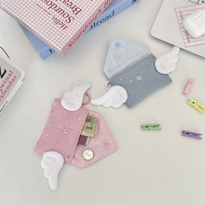 Detailed view of mini envelope coin pouches with plush wings and star sequins