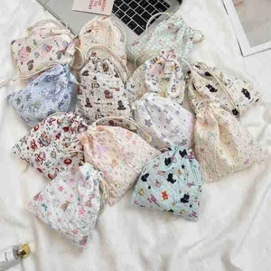 Close-up of patterned drawstring pouches for cosmetics and small accessories storage