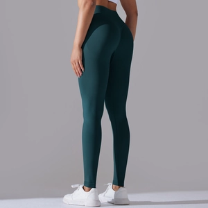 Detailed back view of high-waisted seamless dark green yoga leggings with peach lift design