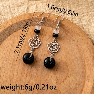 Detailed view of long beaded tassel earrings with flower charm and size specifications