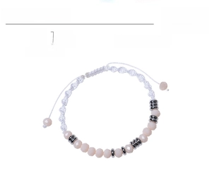 Detail of a 6mm pink crystal beaded bracelet with white braided cord and adjustable pull knot