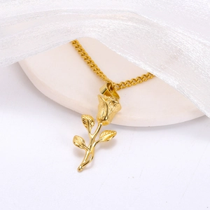 Macro detail of 3D rose flower pendant with delicate petal textures on golden Cuban chain