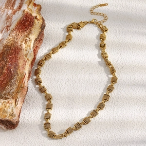Detail of 18K gold-plated stainless steel necklace with textured coils and lobster clasp