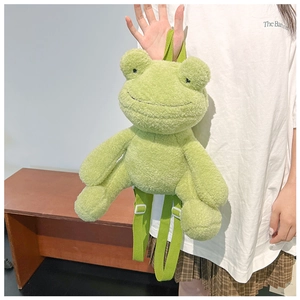 Close-up of cute green plush frog backpack featuring soft material and adjustable straps