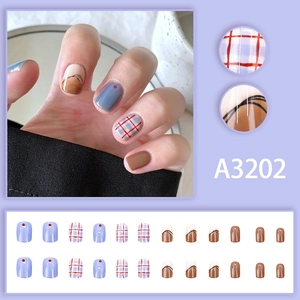 Short red and blue checkered press-on nails set with graffiti patterns and brown accents