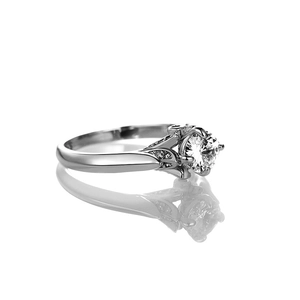 Macro detail of classic six-prong solitaire ring with side stones and mirror reflection