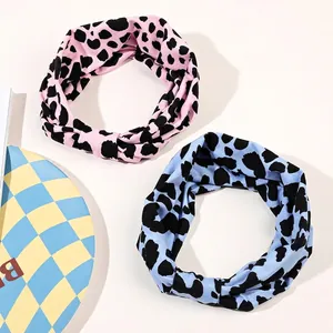 Set of two elastic leopard print sports headbands in pink and blue with knot design