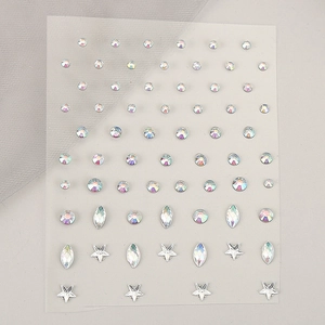 Detailed view of iridescent rhinestone stickers in round, star and teardrop shapes