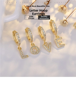 Macro detail of S925 silver gold-plated LOVE letter hoop earrings with AAA zircons