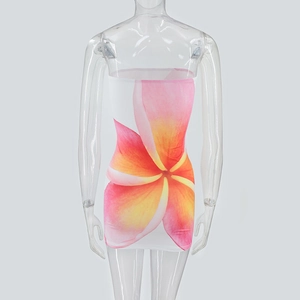 Detail of slim fit strapless dress featuring vibrant pink and orange plumeria floral print