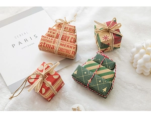 Mini Christmas gift boxes in festive colors on white plush background for store decor