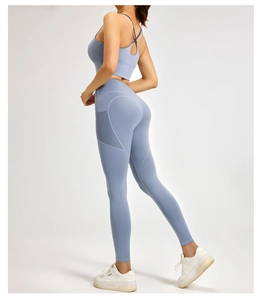 Detail of light blue high waist yoga pants with mesh side pockets for phone storage