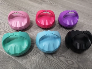 Macro shot of colorful silicone scalp massagers in six shades on wood background