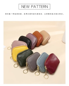 Detail of genuine leather coin pouches with pebble grain texture and gold keyrings