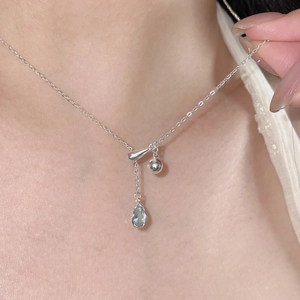 S925 sterling silver necklace with blue teardrop sapphire pendant on model neck