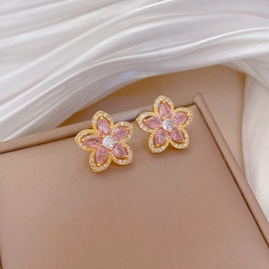Close-up of pink flower stud earrings with gold plating and sparkling zircon petals