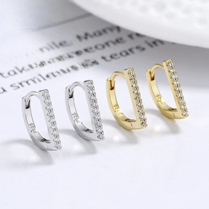 Detail of silver and gold S925 sterling silver hoop earrings with pavé zircon row