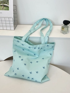 Mint green canvas tote bag with dark blue bird print for daily commuting and shopping