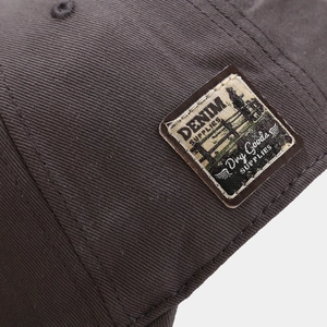 Vintage cotton baseball cap in charcoal gray featuring a retro denim supplies patch