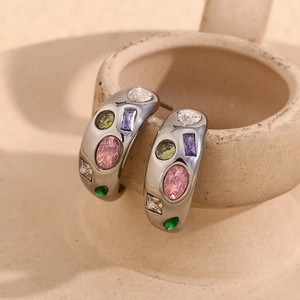 Macro shot of silver wide-band C-shape earrings with colorful micro-set zircon stones
