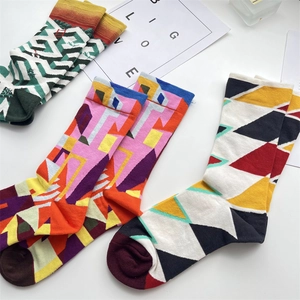 Detailed view of mid-calf cotton socks with colorful artistic geometric patterns