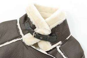 Detail of dark brown leather jacket collar with thick cream faux shearling and metal buckle