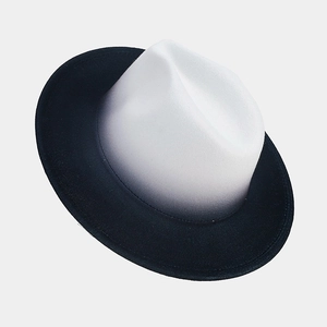 Detail view of the black and white gradient fedora hat with smooth felt texture