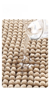 Detail of high-density khaki chenille rug fibers showing instant water absorption