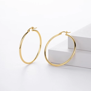Detail view of large gold hollow tube hoop earrings showing the S925 sterling silver stamp