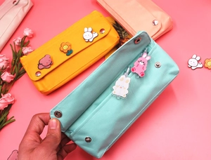 Detail of high-density canvas pencil case with interior pen slots and snap closure