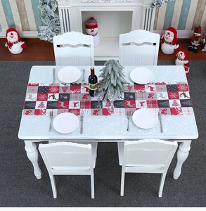 Detail of Christmas table runner with Merry Christmas print and festive elk patterns