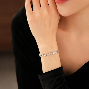 Close-up of zircon star and pearl bracelet with sparkling gemstones on female wrist