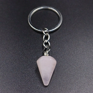 Detailed view of pink rose quartz hexagonal crystal pendant on a silver keychain ring