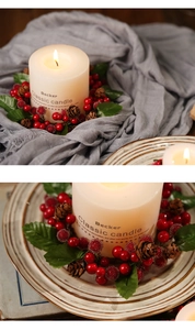 Macro shot of Christmas candle ring with red berries, pine cones and green foliage decor