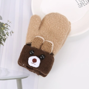 Detailed view of beige knitted mitten with a cute brown bear face and soft wristband