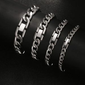 Men's silver stainless steel Cuban link chains in four sizes on a black display stand