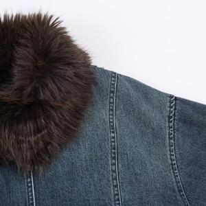Detail of vintage denim jacket showing brown plush faux fur collar and stitching
