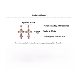 Detail view of colorful rhinestone cross earrings measuring 9cm by 4.4cm with silver pins