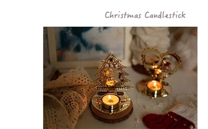 Detail of golden hollow iron Christmas candle holder with reindeer and tree patterns