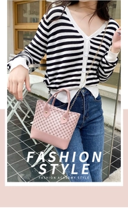 Detailed close-up of pink mini crossbody bag with metal chain strap and printed patterns