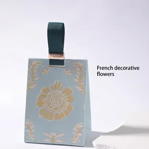 French floral wedding candy box with light blue paper bag and green ribbon handles