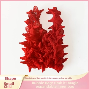 Detail of red popcorn bag showing elastic pleated texture and vibrant bubble fabric