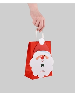 Close-up of small 3D Santa Claus paper gift bag with Merry Christmas text for candies