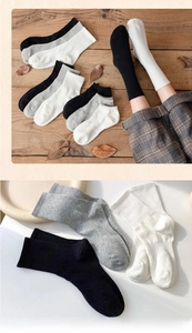 Detailed knit texture of premium cotton crew socks in black, white, and grey tones