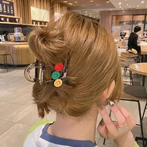 Cute brown translucent star hair claw clip with colorful smiley faces for updo hairstyle